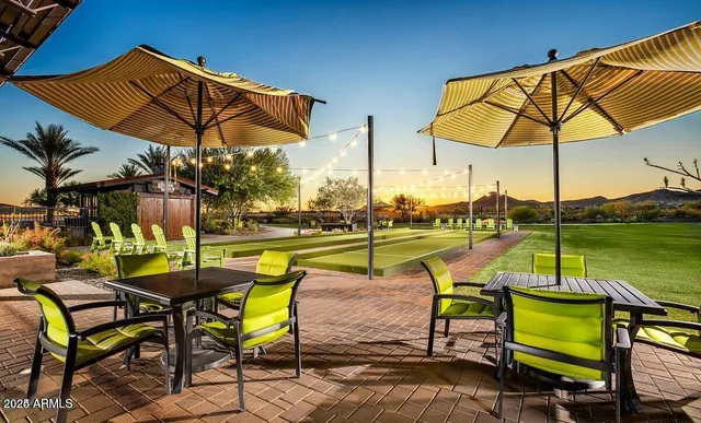 a view of a swimming pool with outdoor seating