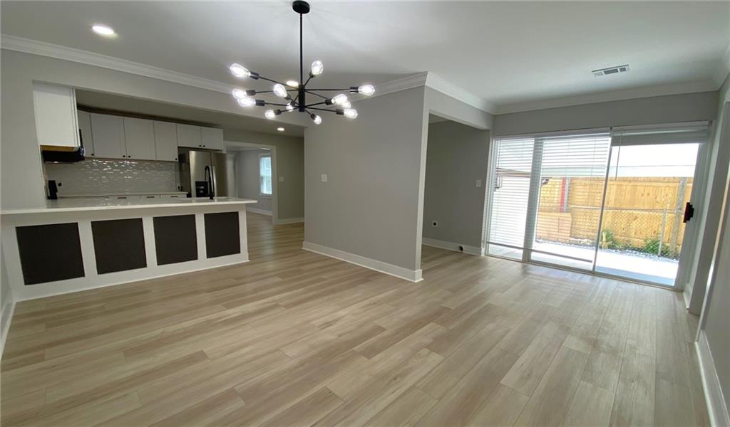 700 Appleton Drive Southeast Marietta, GA 30008 - Photo 12 of 52 a view of a room with wooden floor and a ceiling fan