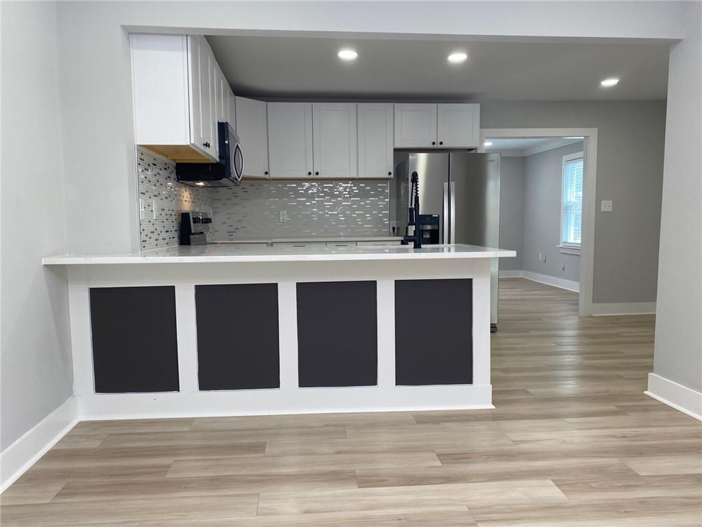 700 Appleton Drive Southeast Marietta, GA 30008 - Photo 13 of 52 a kitchen with kitchen island granite countertop wooden cabinets and refrigerator