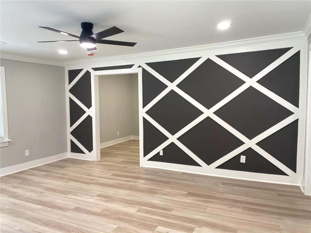 700 Appleton Drive Southeast Marietta, GA 30008 - Photo 17 of 52 an empty room with wooden floor and a ceiling fan