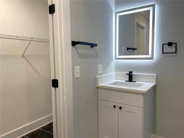 a bathroom with a sink and a mirror