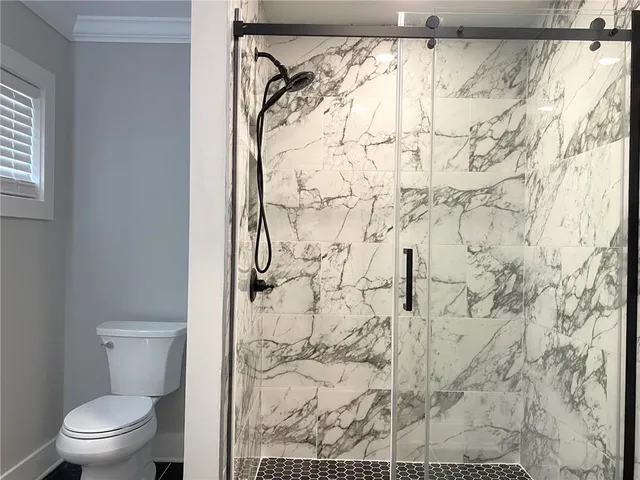 a white toilet sitting next to a shower curtain