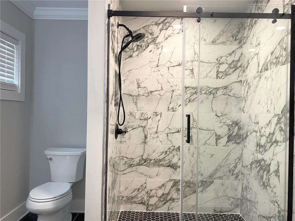 700 Appleton Drive Southeast Marietta, GA 30008 - Photo 24 of 52 a white toilet sitting next to a shower curtain