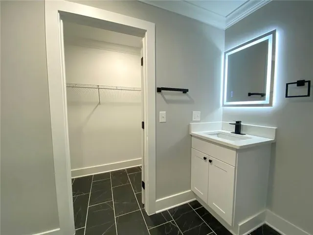 a bathroom with a shower sink and mirror