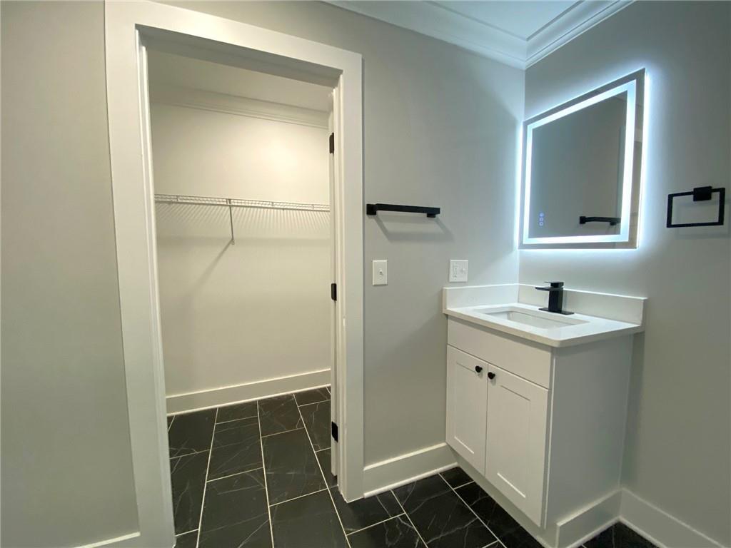 700 Appleton Drive Southeast Marietta, GA 30008 - Photo 25 of 52 a bathroom with a shower sink and mirror