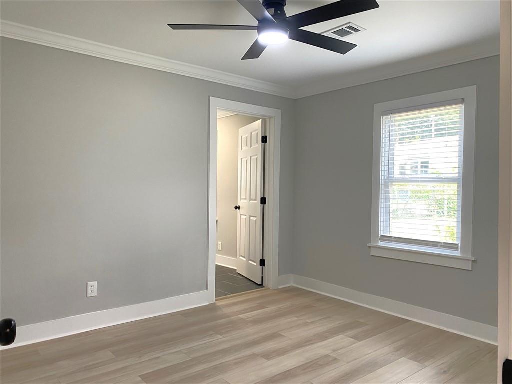 700 Appleton Drive Southeast Marietta, GA 30008 - Photo 29 of 52 an empty room with wooden floor and windows
