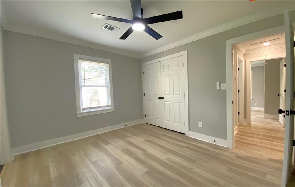 700 Appleton Drive Southeast Marietta, GA 30008 - Photo 30 of 52 a view of empty room with wooden floor and fan