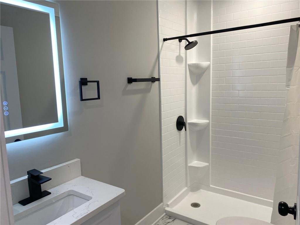 700 Appleton Drive Southeast Marietta, GA 30008 - Photo 39 of 52 a bathroom with a shower and a toilet