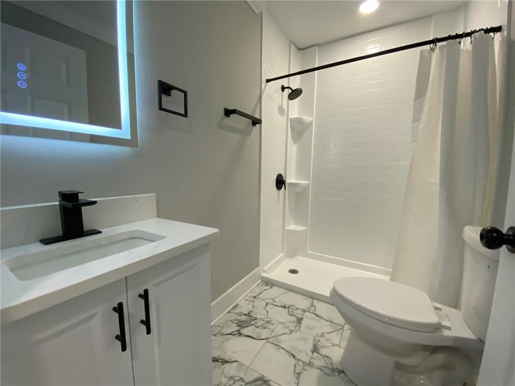 700 Appleton Drive Southeast Marietta, GA 30008 - Photo 40 of 52 a bathroom with a sink toilet and shower