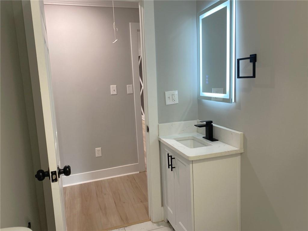 700 Appleton Drive Southeast Marietta, GA 30008 - Photo 41 of 52 a bathroom with a granite countertop sink toilet and shower