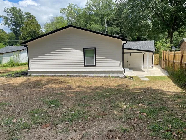 a view of a house with wooden fence