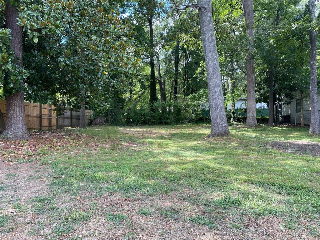 700 Appleton Drive Southeast Marietta, GA 30008 - Photo 49 of 52 a backyard of a house with lots of plants and large tree