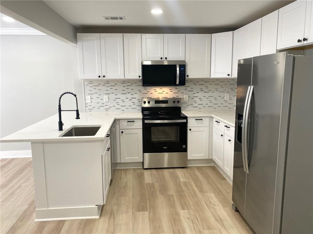 700 Appleton Drive Southeast Marietta, GA 30008 - Photo 6 of 52 a kitchen with stainless steel appliances a refrigerator stove and sink
