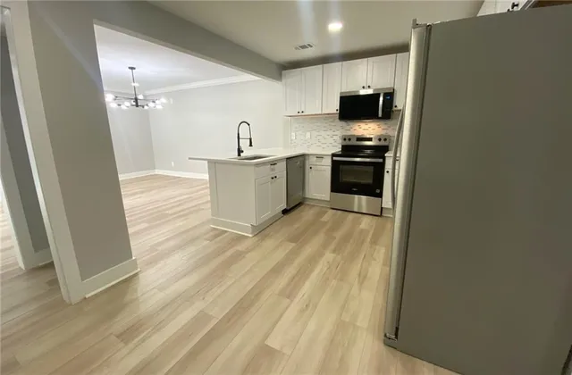 a kitchen with a sink and a refrigerator