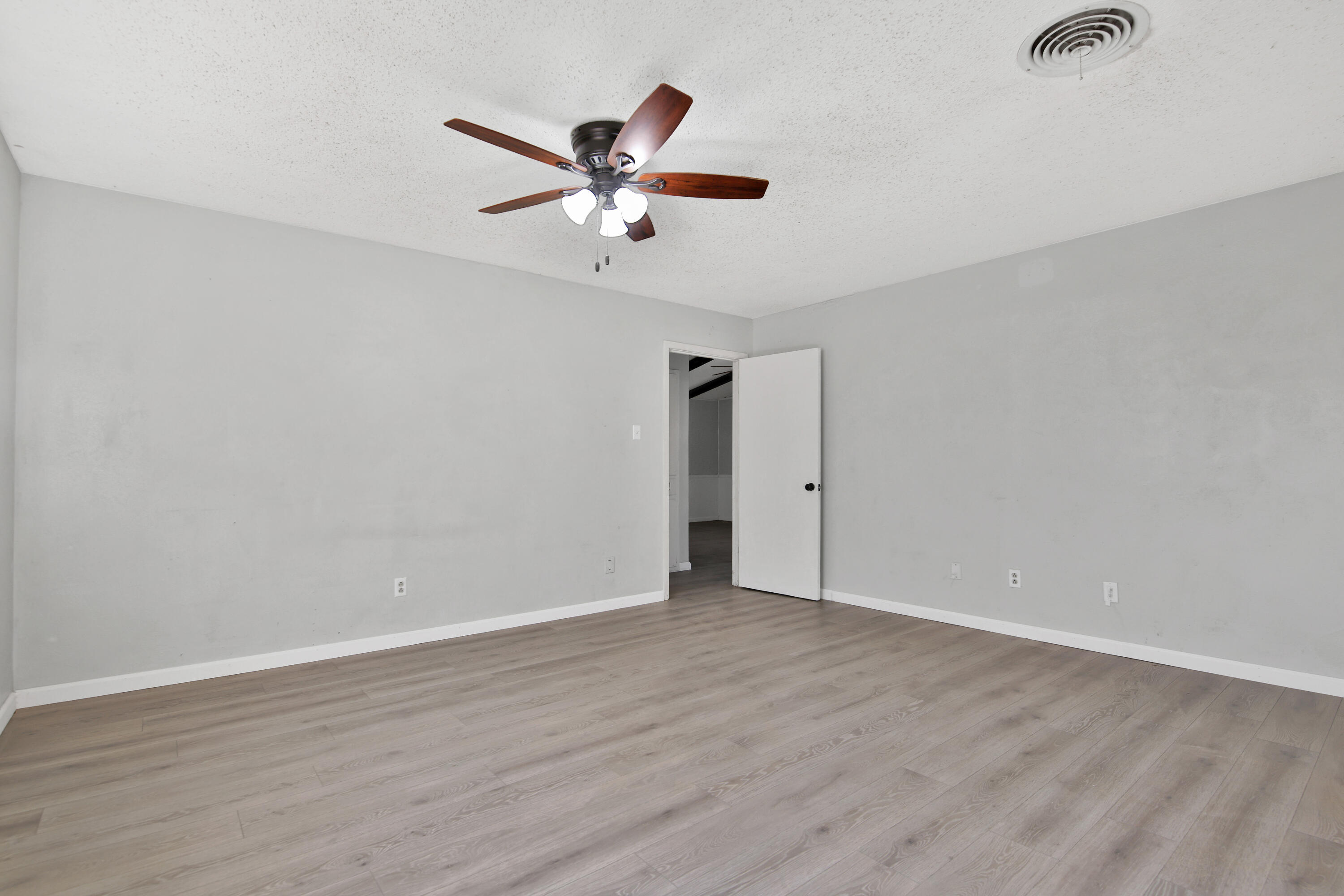6607 Avenue U Lubbock, TX 79412 - Photo 13 of 25 an empty room with wooden floor closet and fan