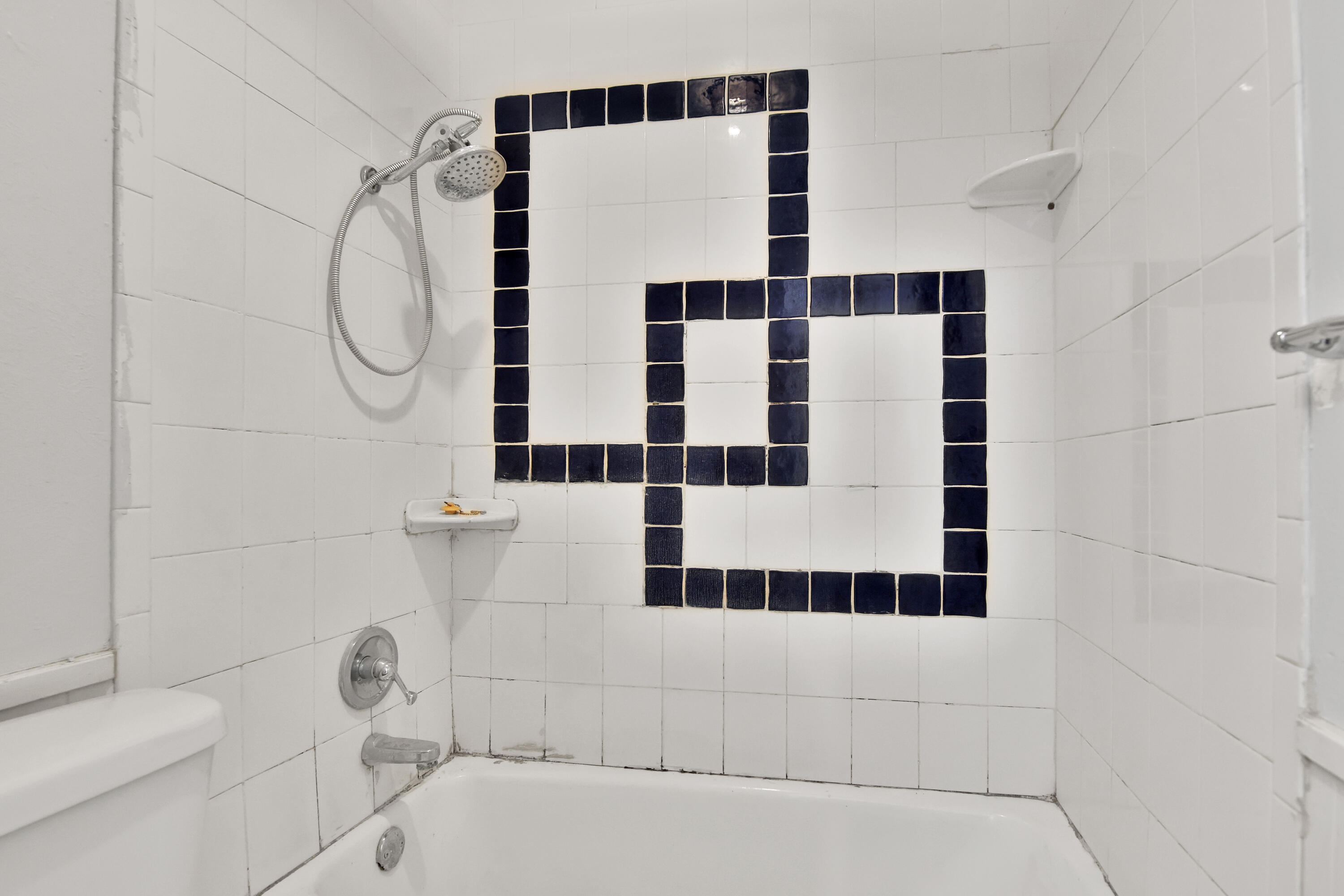 6607 Avenue U Lubbock, TX 79412 - Photo 15 of 25 a bathroom with a black and white shower curtain