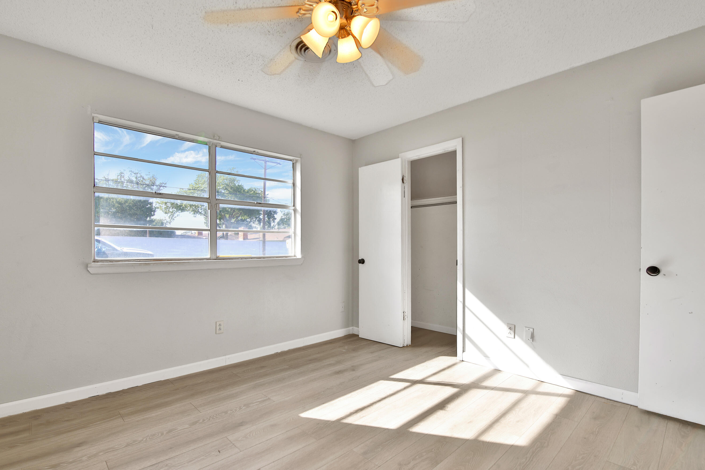 6607 Avenue U Lubbock, TX 79412 - Photo 17 of 25 a view of an empty room with wooden floor and a window