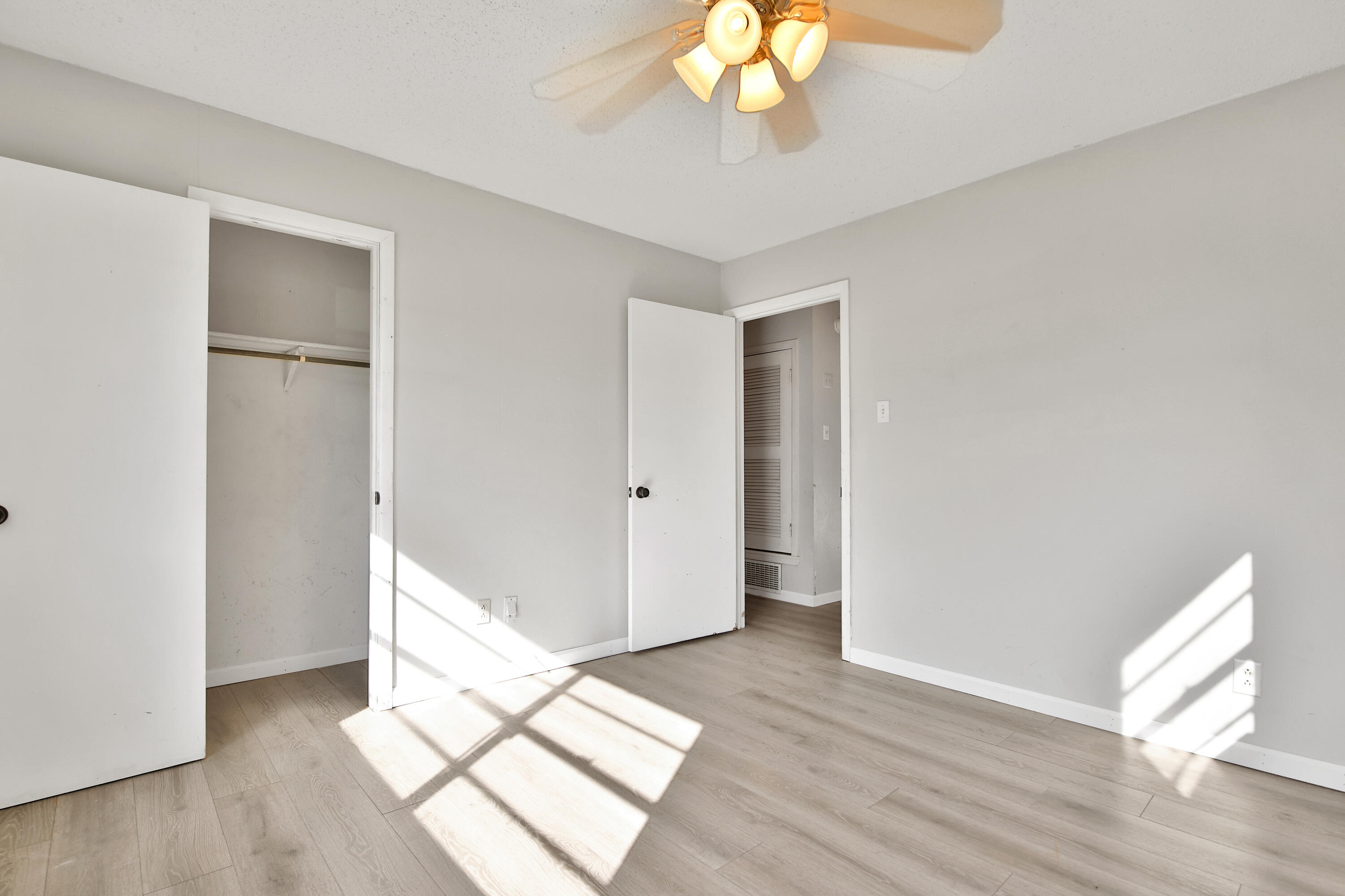 6607 Avenue U Lubbock, TX 79412 - Photo 18 of 25 a view of an empty room with wooden floor and a window