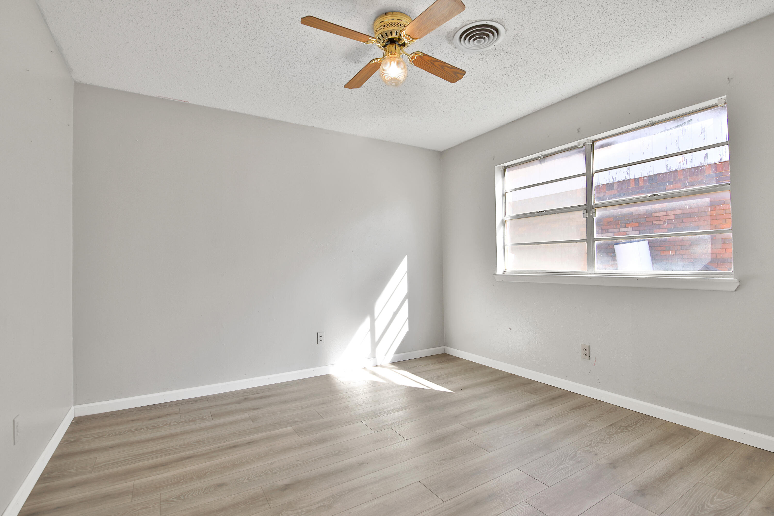 6607 Avenue U Lubbock, TX 79412 - Photo 19 of 25 wooden floor in an empty room with a window