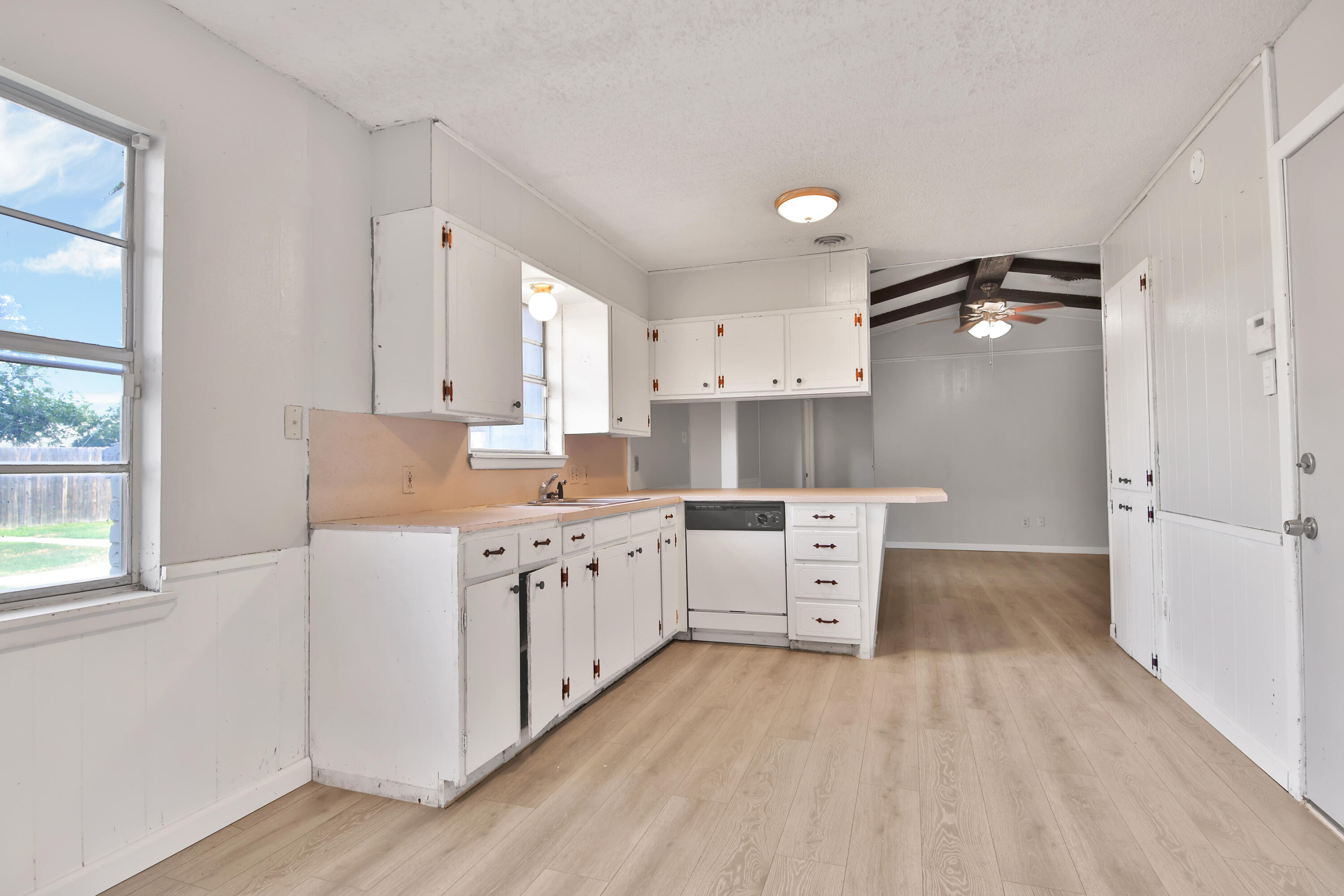 6607 Avenue U Lubbock, TX 79412 - Photo 8 of 25 a kitchen with white cabinets and white appliances