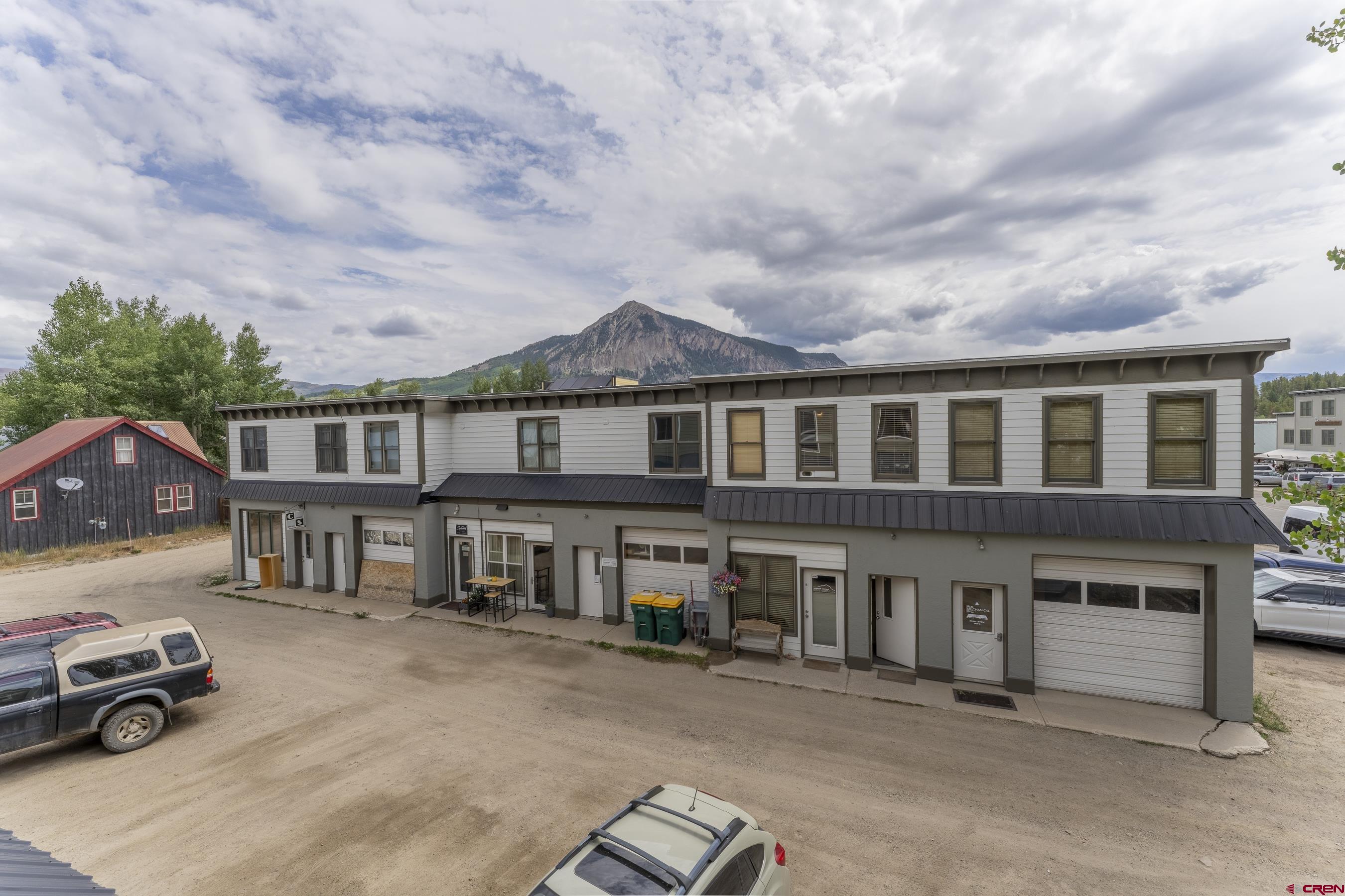 309 Belleview Avenue, Unit 2A Crested Butte, CO 81224 - Photo 7 of 22 a front view of a residential apartment building with a yard