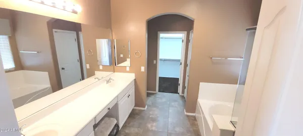 a bathroom with a bathtub sink and vanity