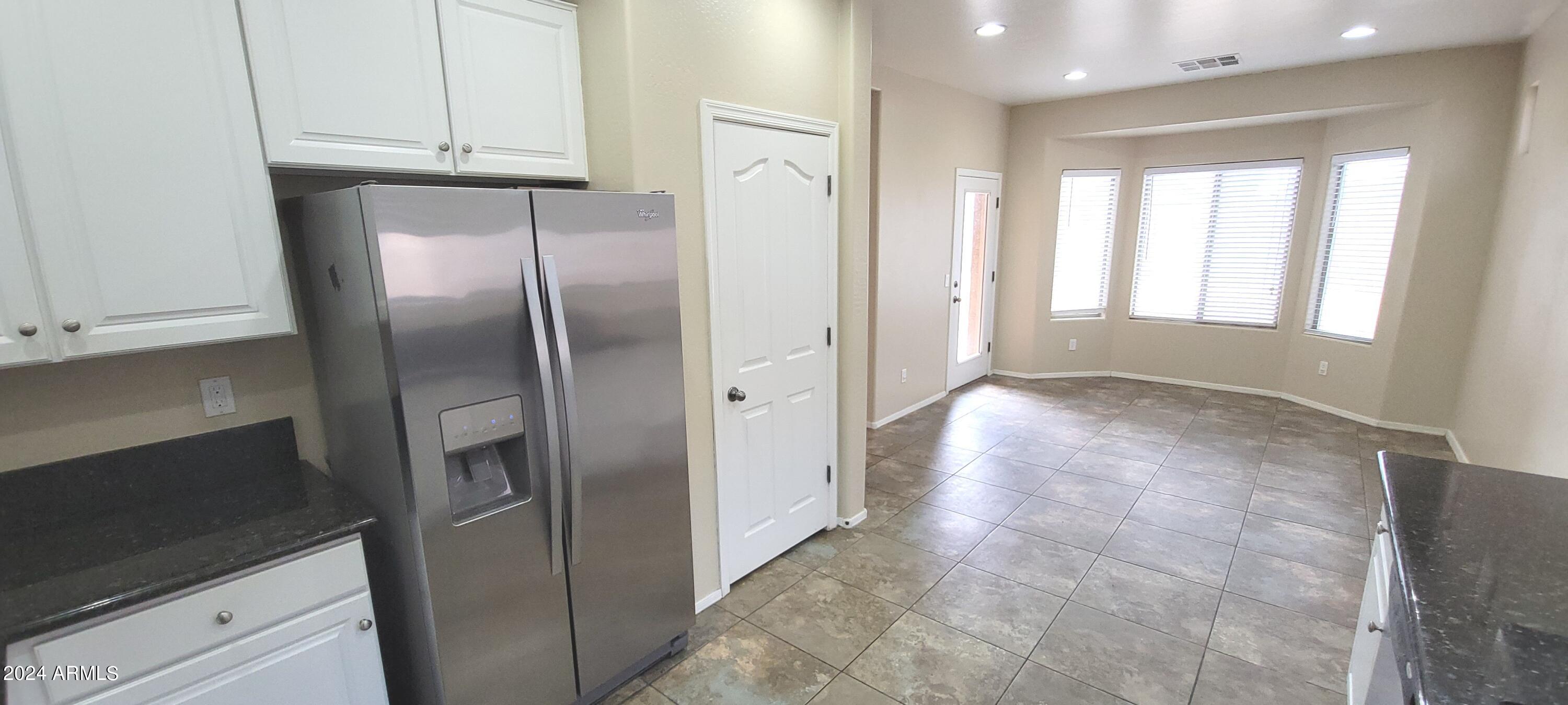 11537 East Sebring Avenue Mesa, AZ 85212 - Photo 4 of 24 a view of a refrigerator in kitchen and window