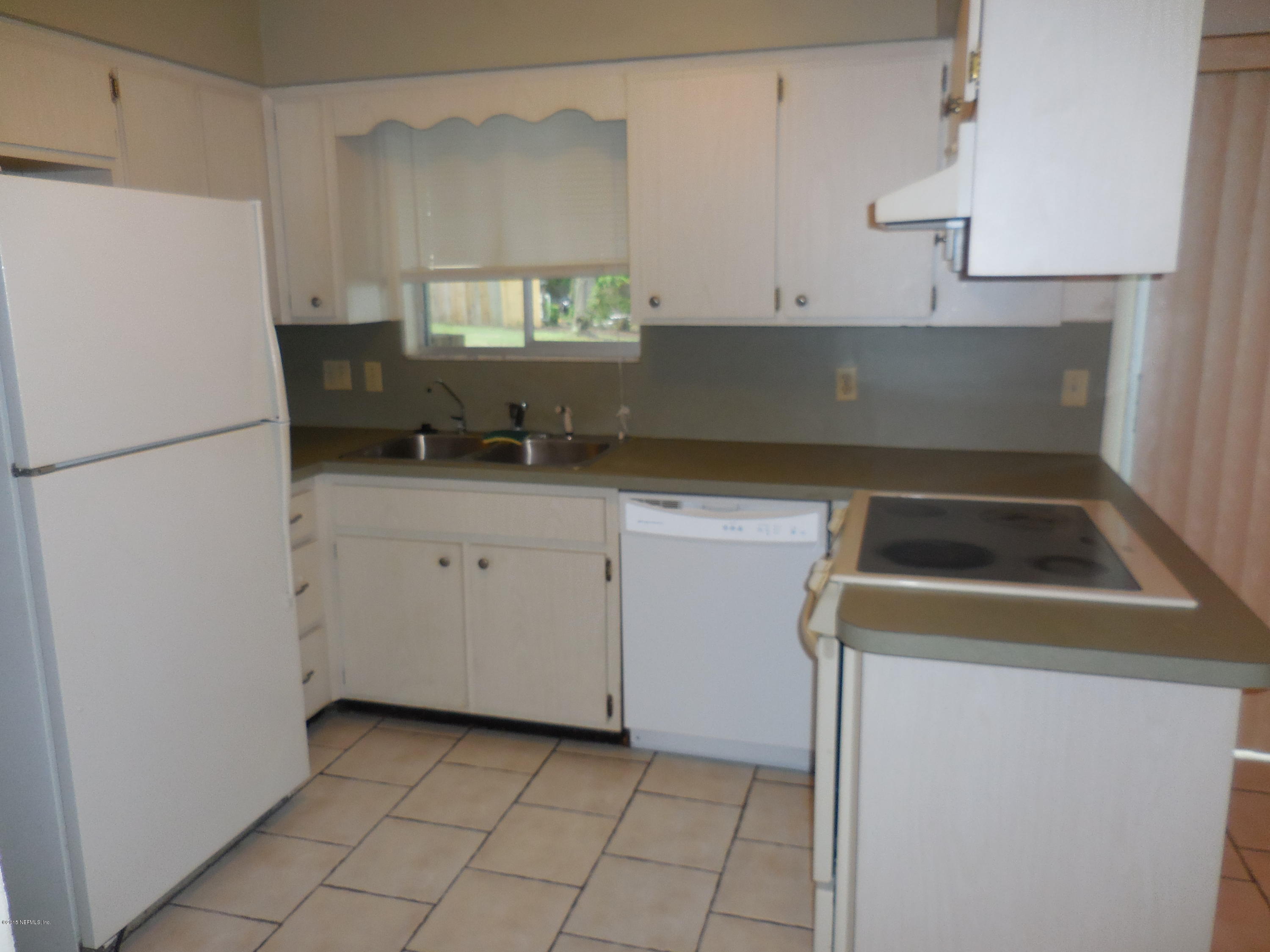 10402 Tulsa Road Jacksonville, FL 32218 - Photo 14 of 34 a kitchen with a sink a stove and a refrigerator