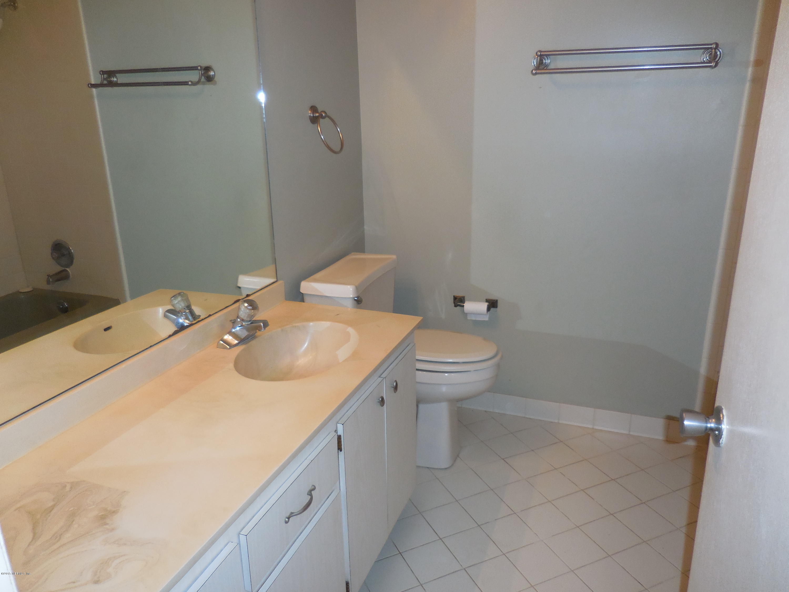 10402 Tulsa Road Jacksonville, FL 32218 - Photo 19 of 34 a bathroom with a sink toilet and shower