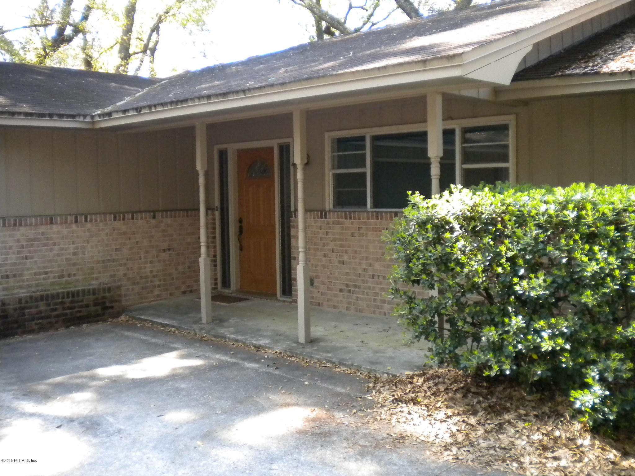 10402 Tulsa Road Jacksonville, FL 32218 - Photo 3 of 34 a front view of a house with a yard and garage