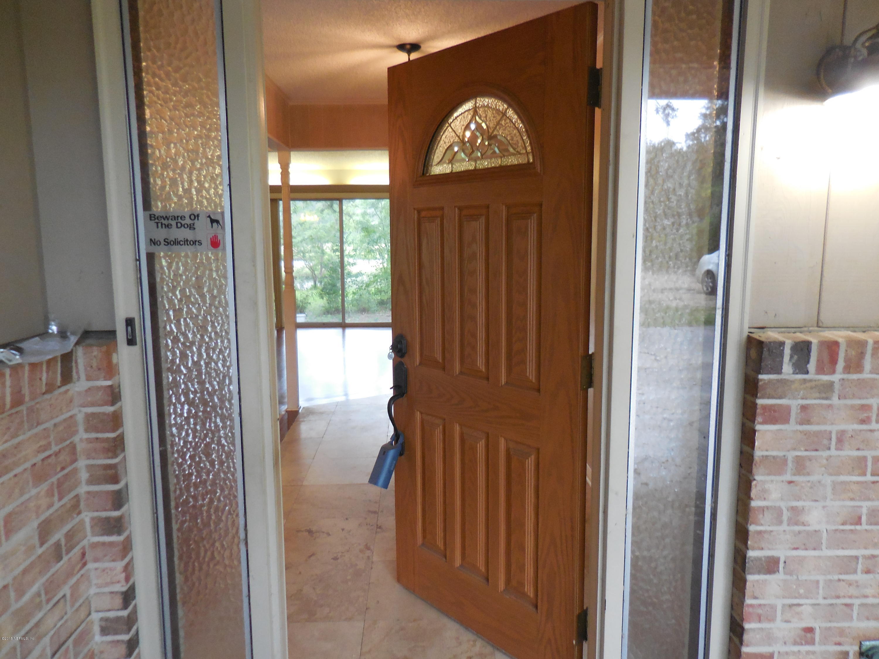 10402 Tulsa Road Jacksonville, FL 32218 - Photo 7 of 34 a view of front door with wooden door