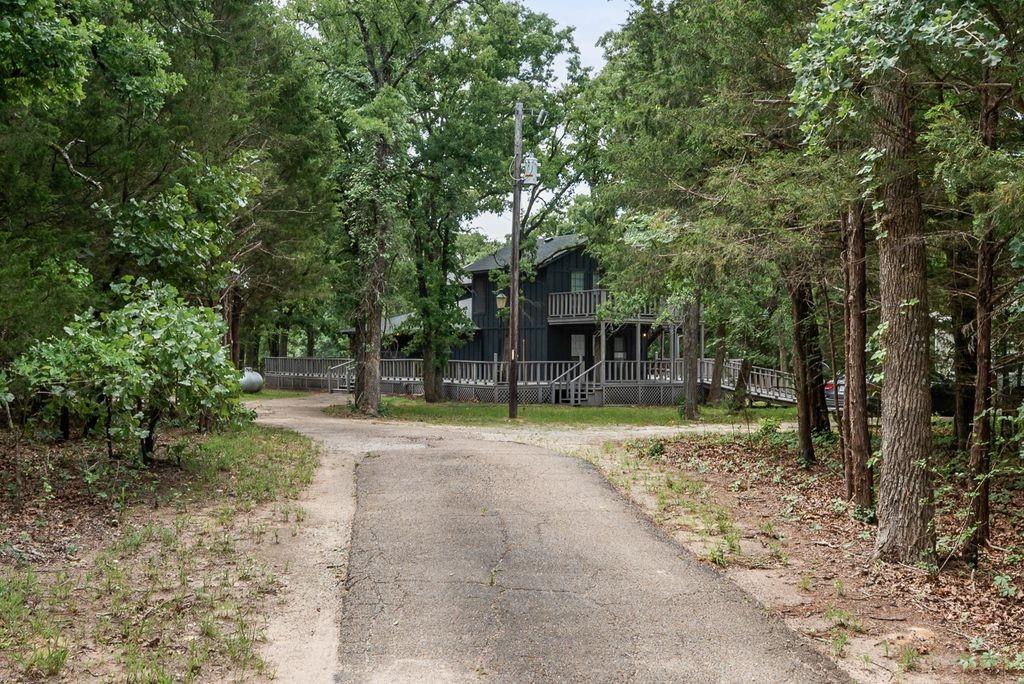 9875 Old Bridge Road Terrell, TX 75160 - Photo 7 of 40 a view of house with backyard and trees
