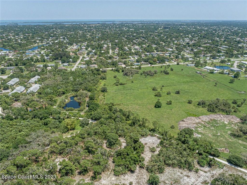 10995 Roseland Road Sebastian, FL 32958 - Photo 28 of 35 a view of a green field with lots of bushes