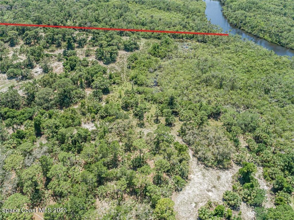 10995 Roseland Road Sebastian, FL 32958 - Photo 31 of 35 an aerial view of a houses with a yard and flowers