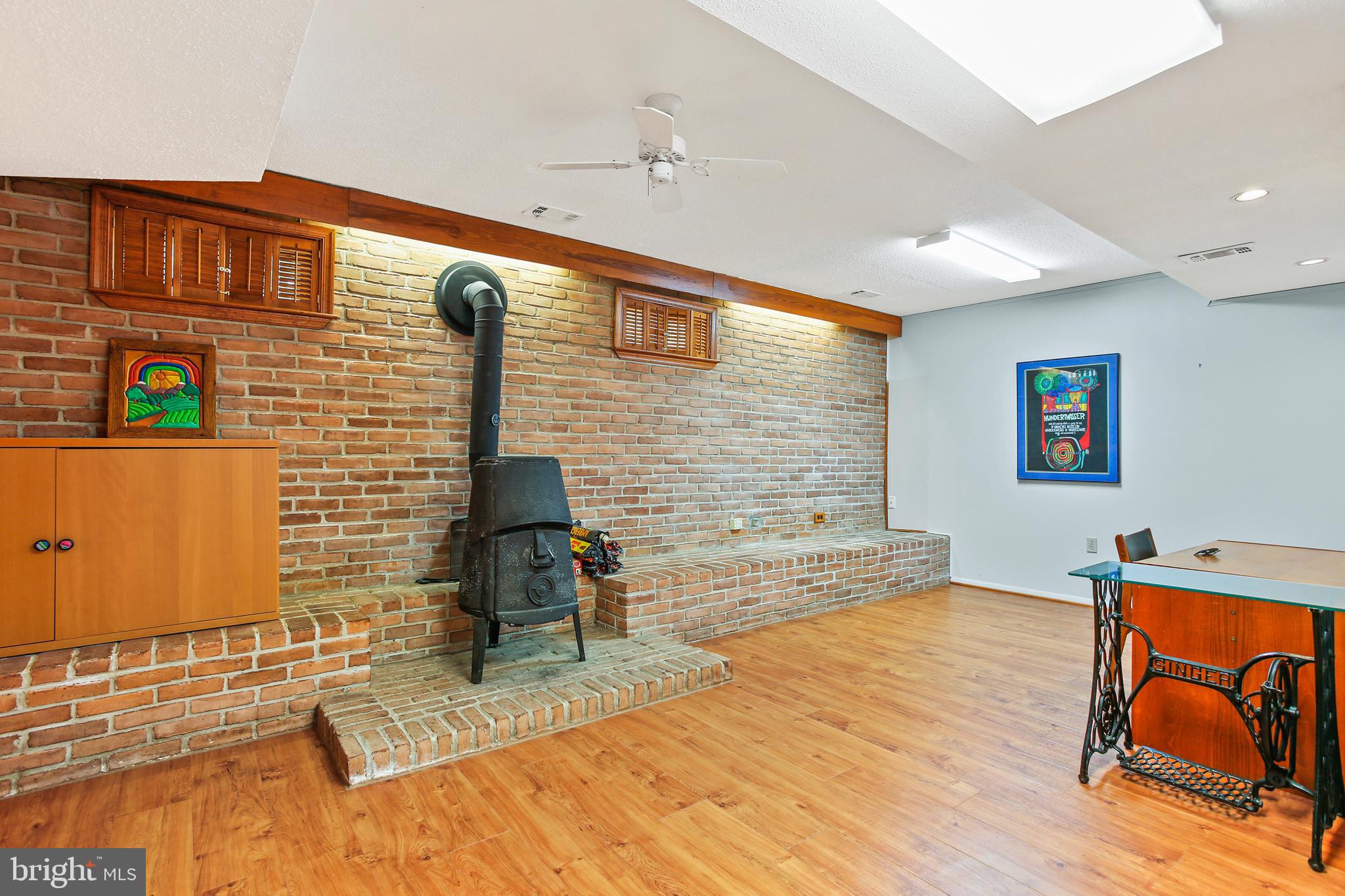 8216 Scotts Level Road Pikesville, MD 21208 - Photo 28 of 42 Rec Room w/ Wood Stove & New Luxury Vinyl Flooring