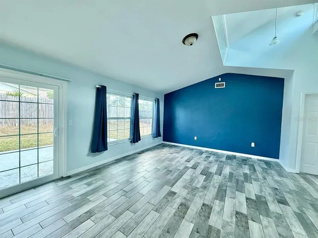 a kitchen with stainless steel appliances granite countertop a table chairs refrigerator and sink