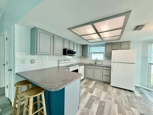 a kitchen with cabinets and white appliances
