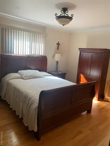 a bedroom with bed and window