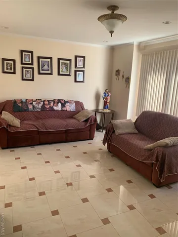 a living room with a couch and a window