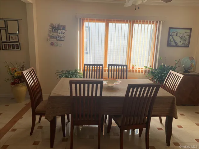 a view of a dining room with furniture a chandelier and wooden floor