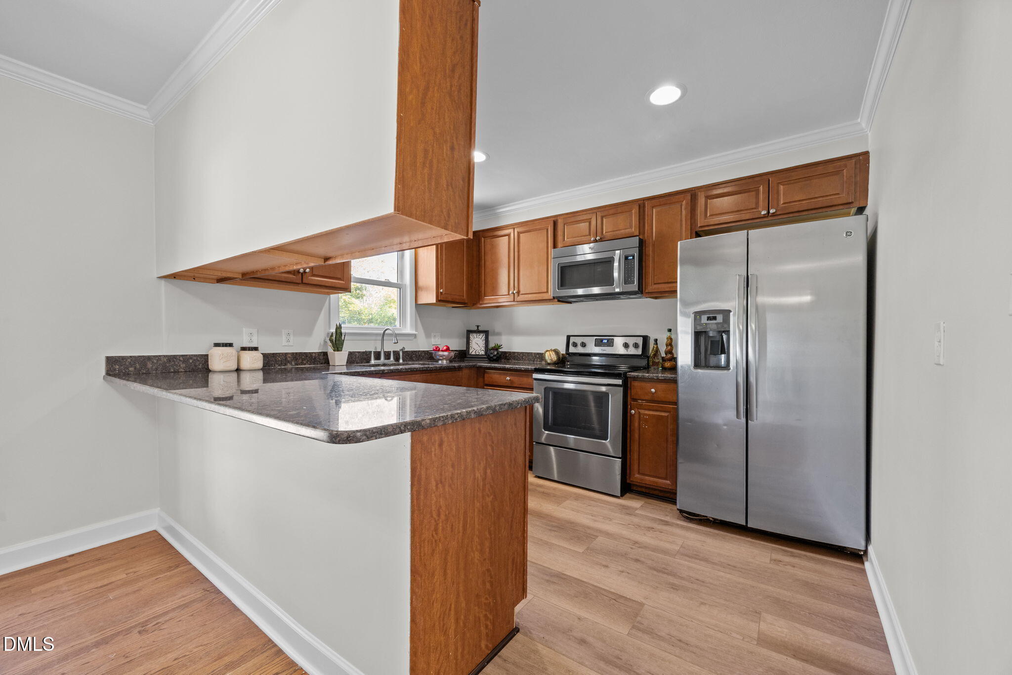 518 Kenway Street Garner, NC 27529 - Photo 7 of 14 a kitchen with stainless steel appliances granite countertop a refrigerator and a sink
