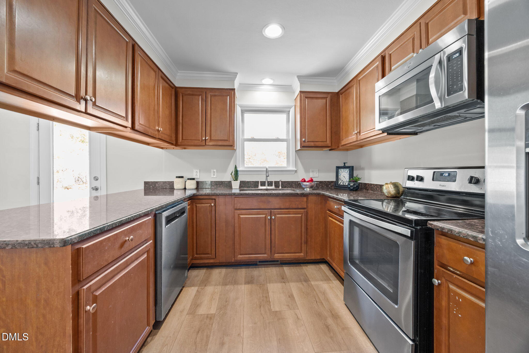 518 Kenway Street Garner, NC 27529 - Photo 8 of 14 a kitchen with stainless steel appliances granite countertop a sink and cabinets