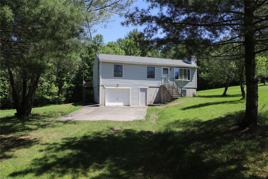 a front view of house with yard and green space