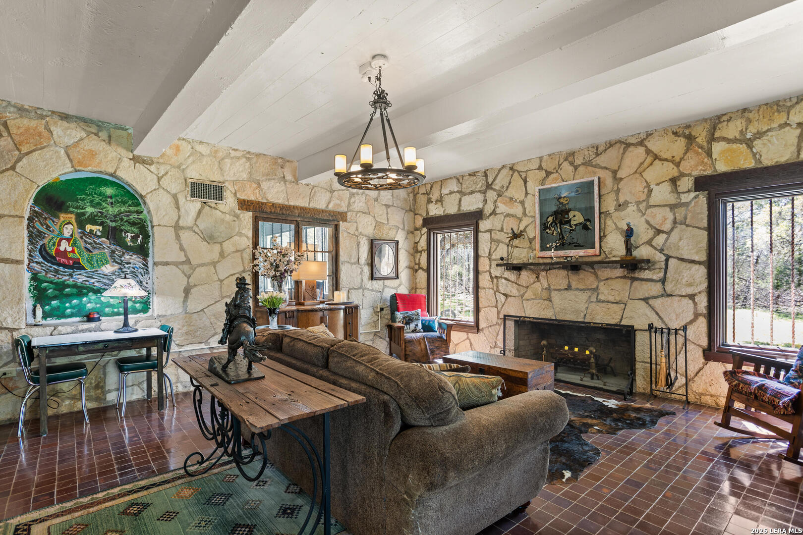 132 Ridge Place Boerne, TX 78006 - Photo 12 of 40 a living room with furniture a fireplace and a floor to ceiling window