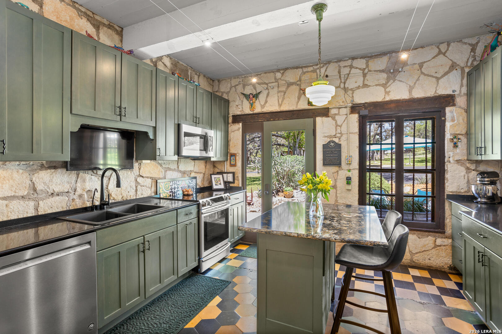 132 Ridge Place Boerne, TX 78006 - Photo 21 of 40 a kitchen with stainless steel appliances granite countertop a sink cabinets a stove and a refrigerator