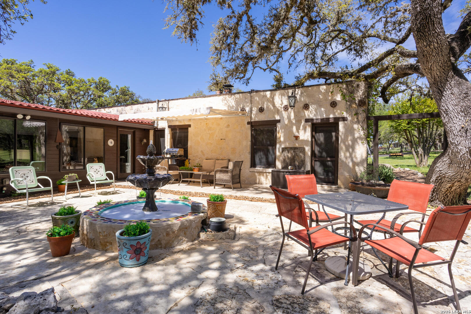 132 Ridge Place Boerne, TX 78006 - Photo 33 of 40 a view of a patio with table and chairs and potted plants