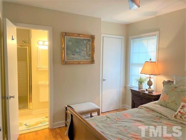701 Dixie Trail Raleigh, NC 27607 - Photo 11 of 26 a bedroom with a bed and a lamp next to a window