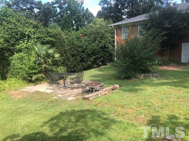 701 Dixie Trail Raleigh, NC 27607 - Photo 3 of 26 a view of a backyard with table and chairs and potted plants