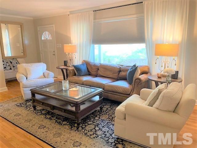 701 Dixie Trail Raleigh, NC 27607 - Photo 5 of 26 a living room with furniture and a large window