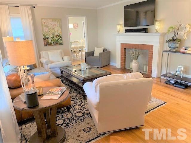 701 Dixie Trail Raleigh, NC 27607 - Photo 6 of 26 a living room with furniture and a fireplace